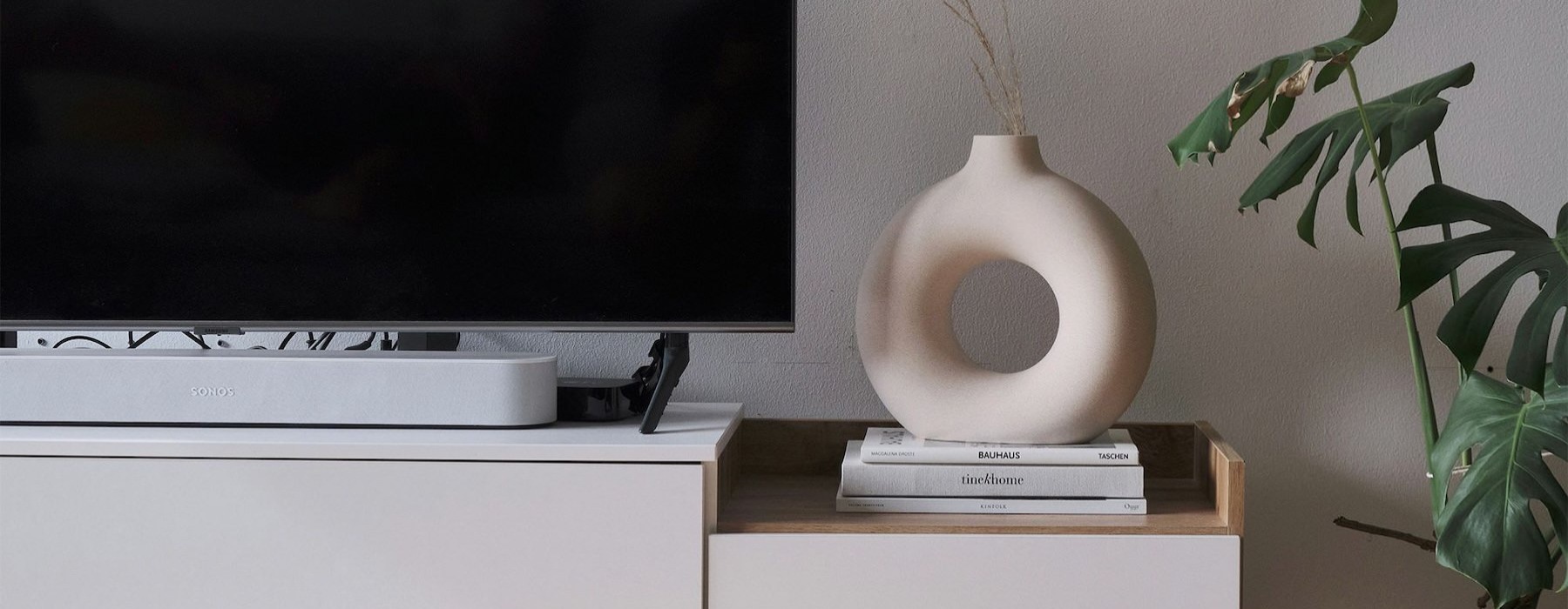 a tv on a stand with decor