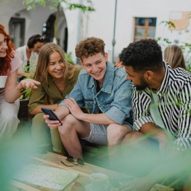 A group of people sitting at a table laughing with each other.